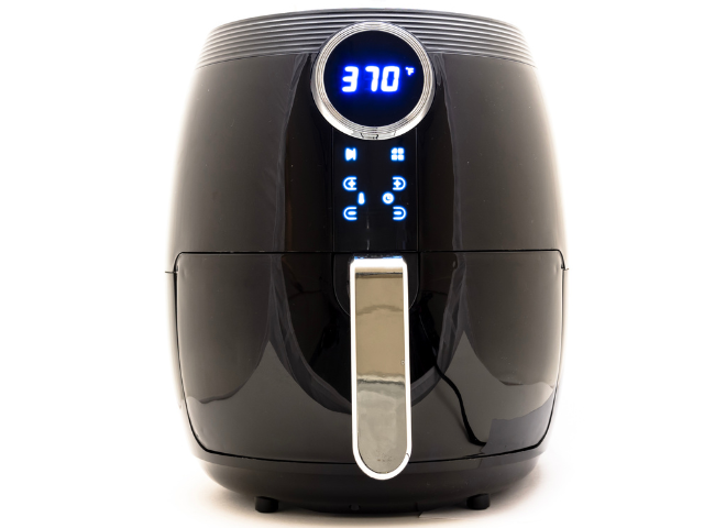 A black air fryer displaying a temperature of 370°F on its LED screen.