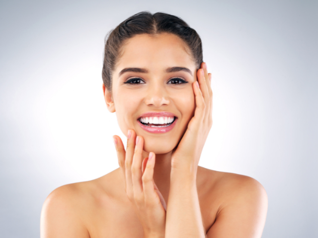 A woman smiling with healthy skin