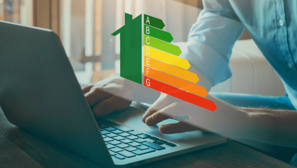 A person typing on a laptop with an energy efficiency rating scale from A to G superimposed on the image.