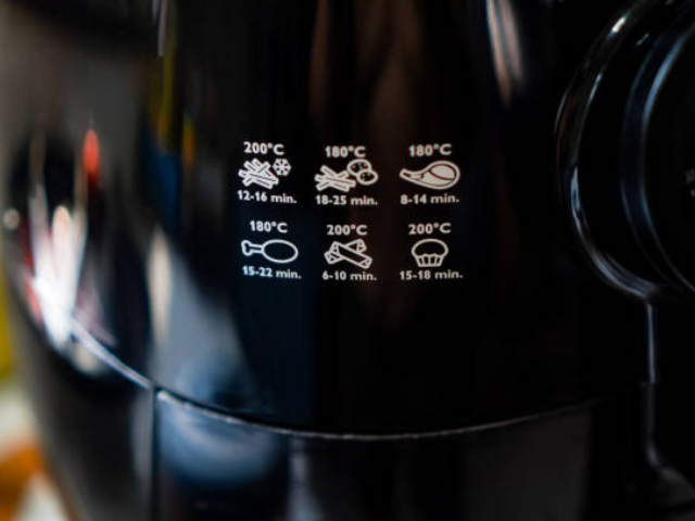 Cartoon illustrations of an air fryer from three angles on an orange background.