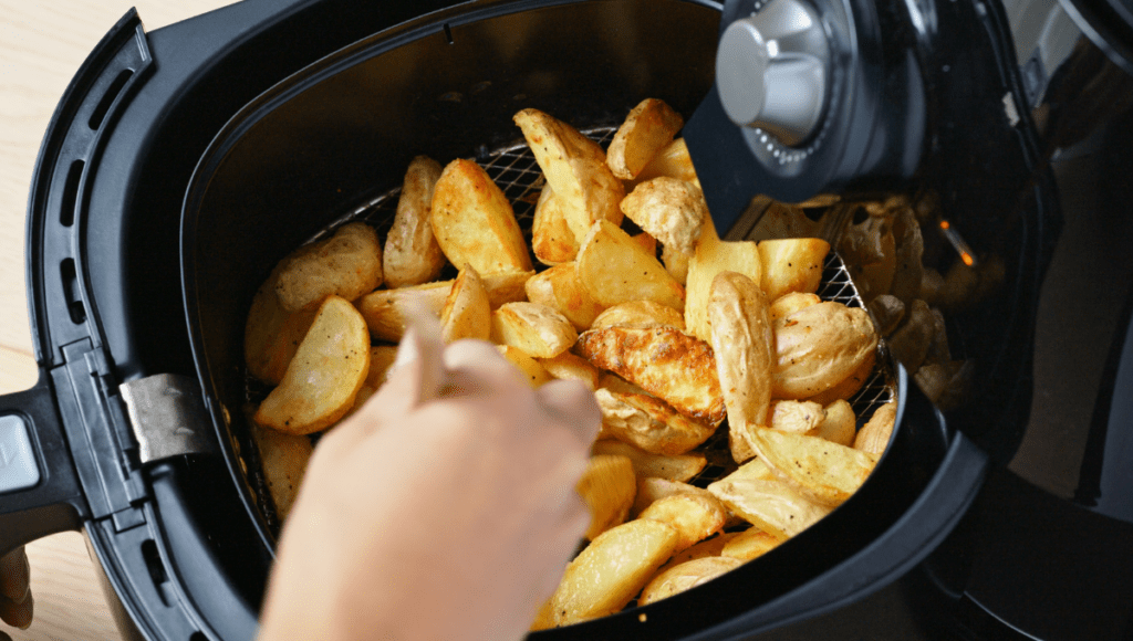 Potatoes inside a black air fryer