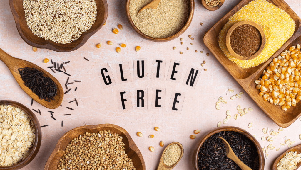 A variety of gluten-free grains and seeds arranged with a sign that reads 'Gluten Free'.