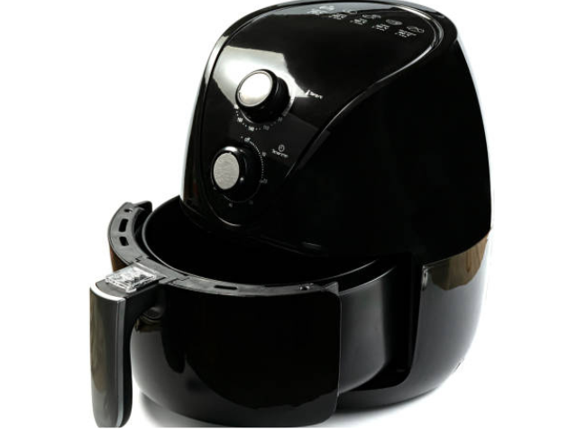 A black air fryer on a white background with a basket partially pulled out.